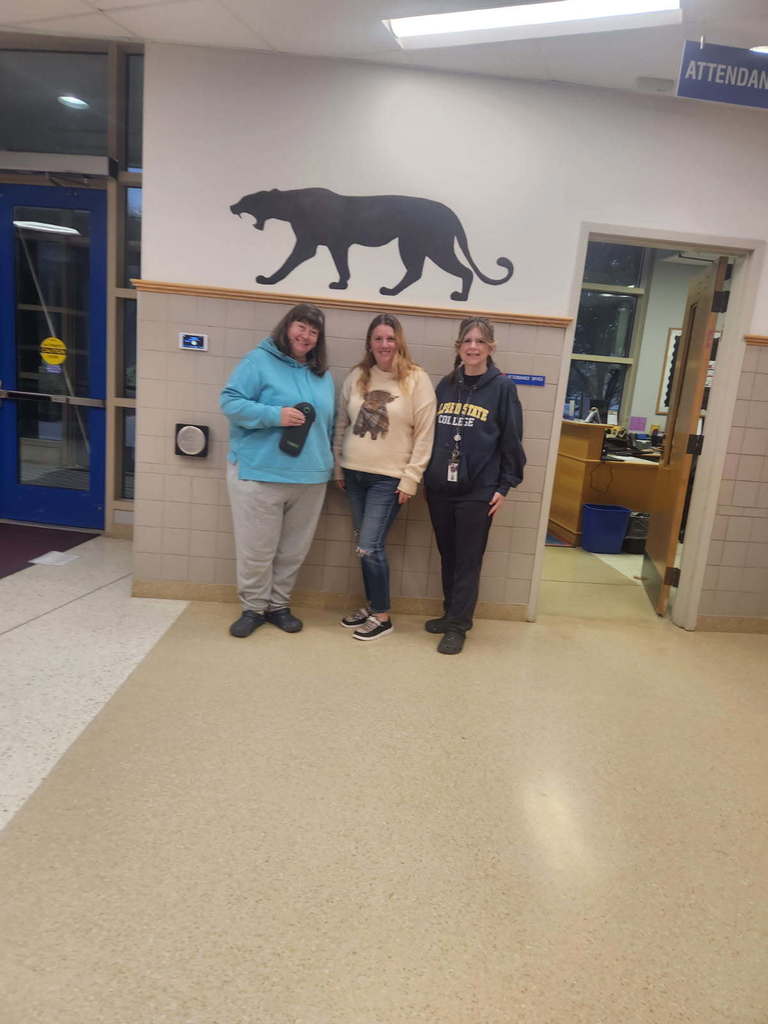3 educators dressed as students in sweatshirts