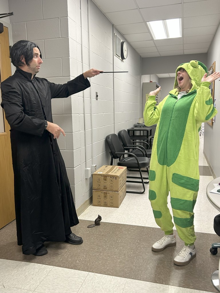 Teacher and student posing dressed up as a wizard and frog
