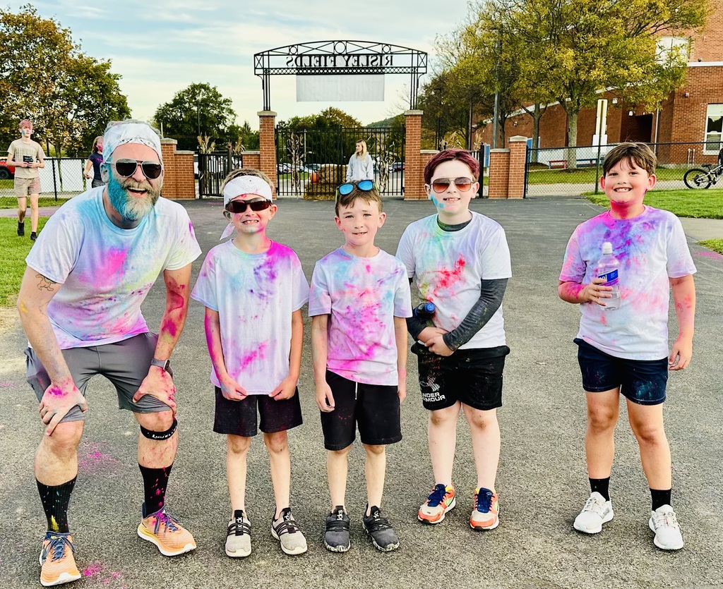 Group photo of students posing with teacher after the color run