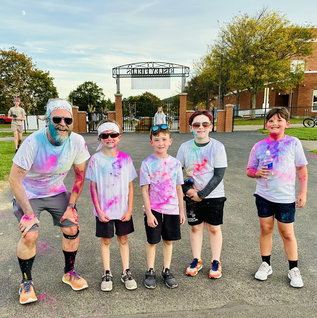Group photo of students posing with teacher after the color run