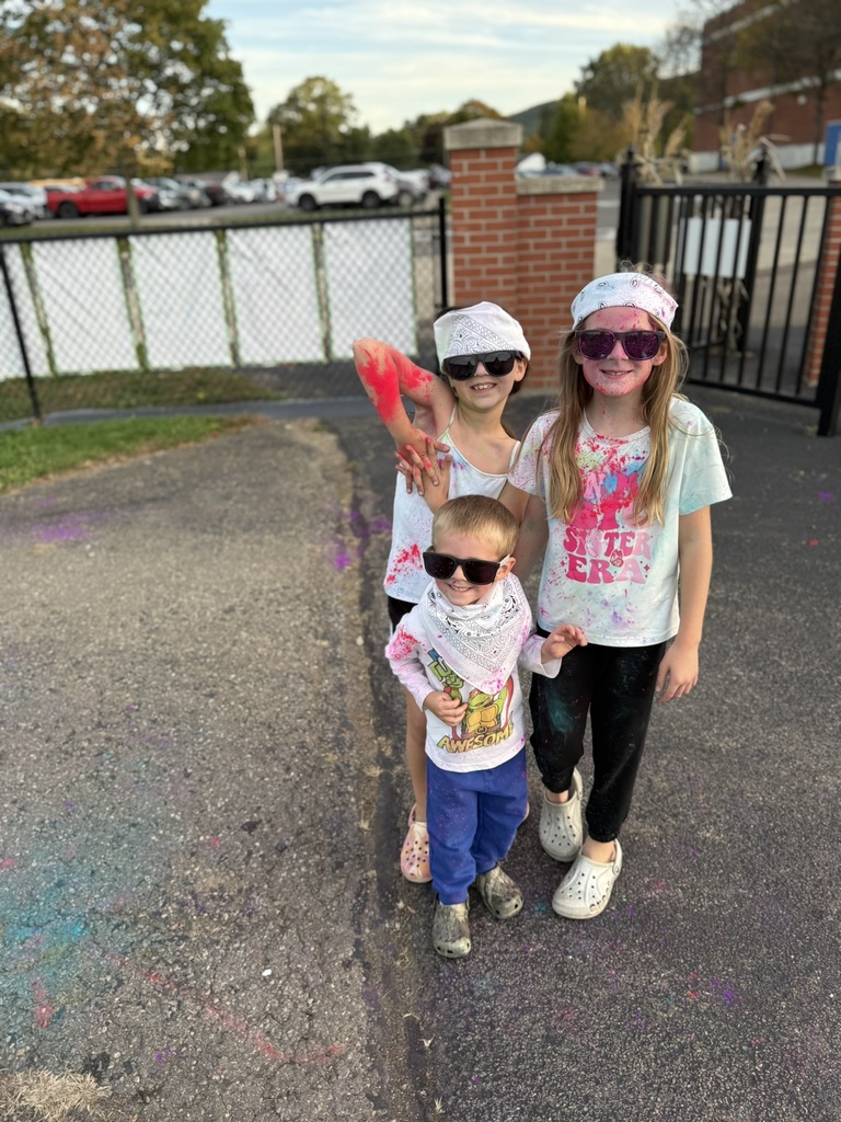 Students posing after color run one with sunglasses on