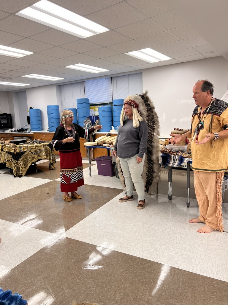Teacher being dressed in Native American Head Dress