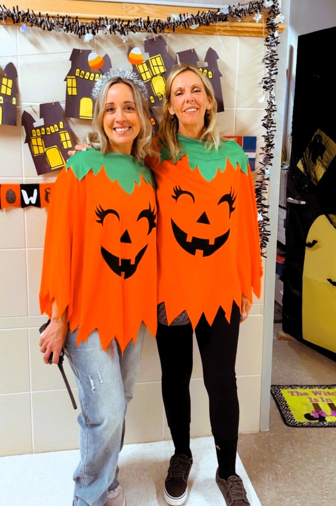 Two teachers dressed as jack o lanterns
