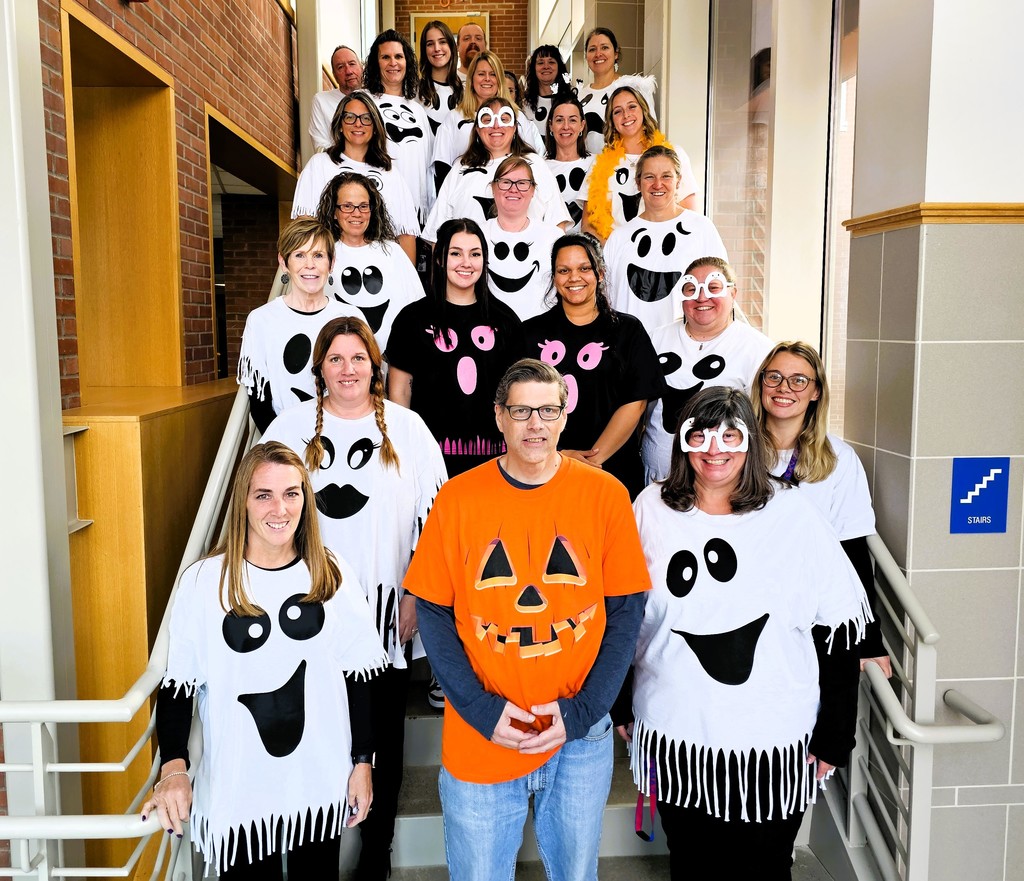 Faculty pic in stairwell dressed as ghosts
