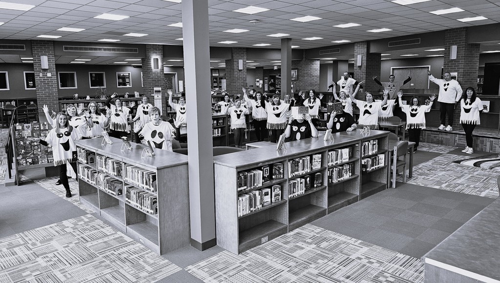 faculty library pic all dressed as ghosts in black and white