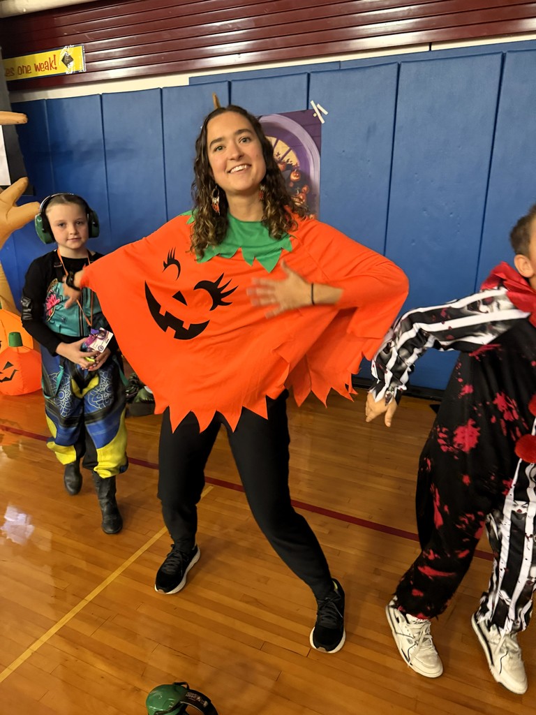 PE Teacher dressed as a jack o lantern dancing