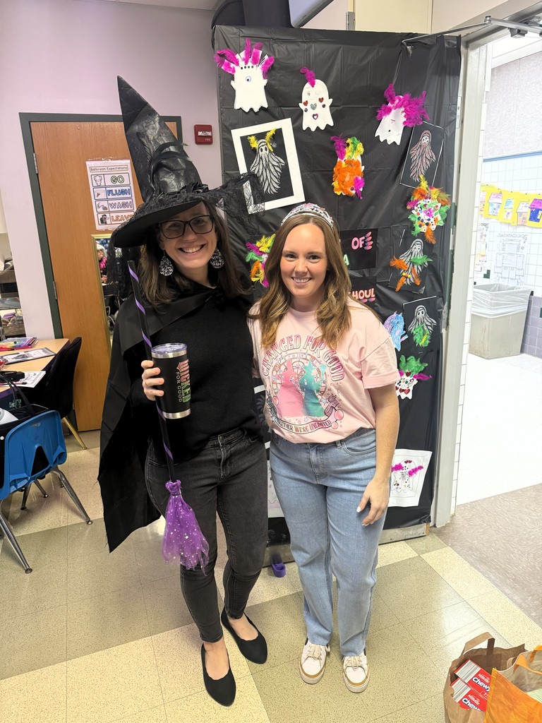 Picture of principal and ap, one dressed as a witch the other a princess
