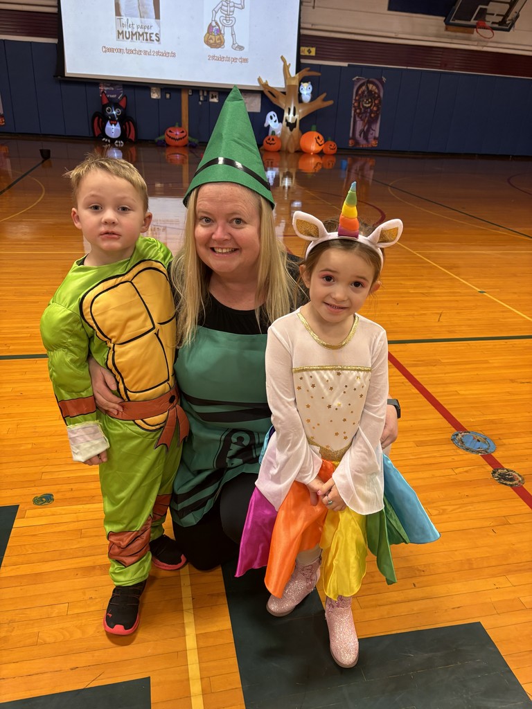 Teacher and two students posing for picture dressed up for halloween