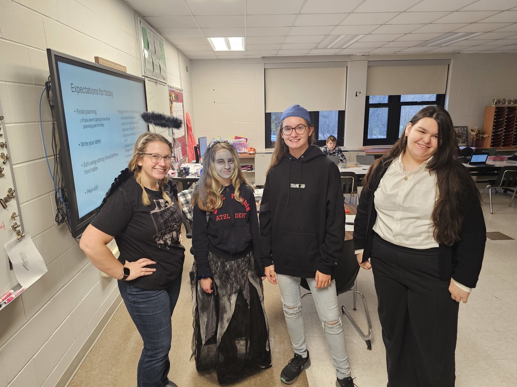 3 students and a teacher posing for halloween pic