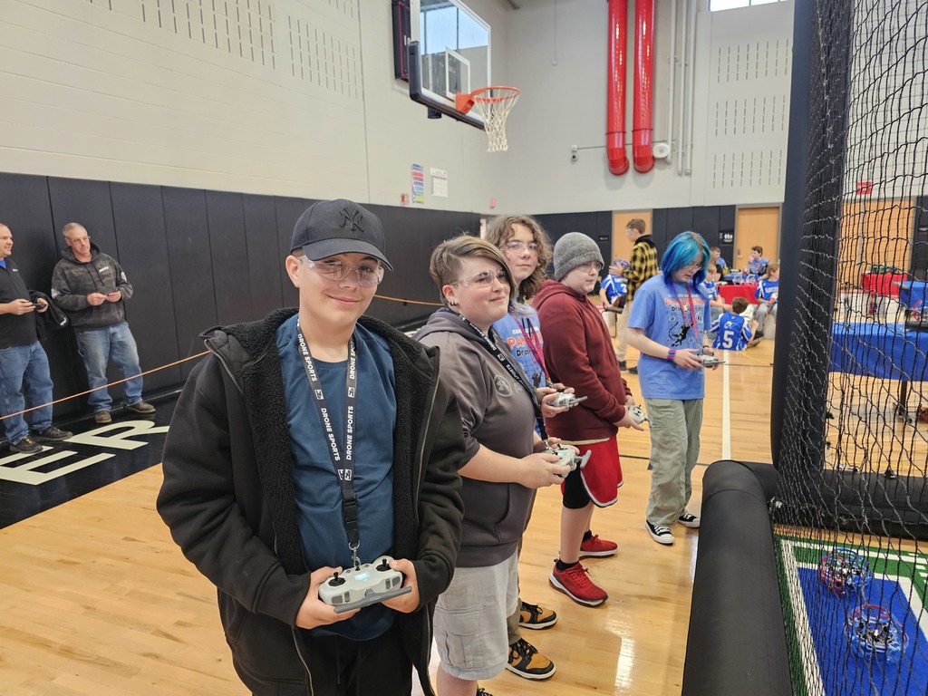 Drone soccer team lined up with controllers ready to fly