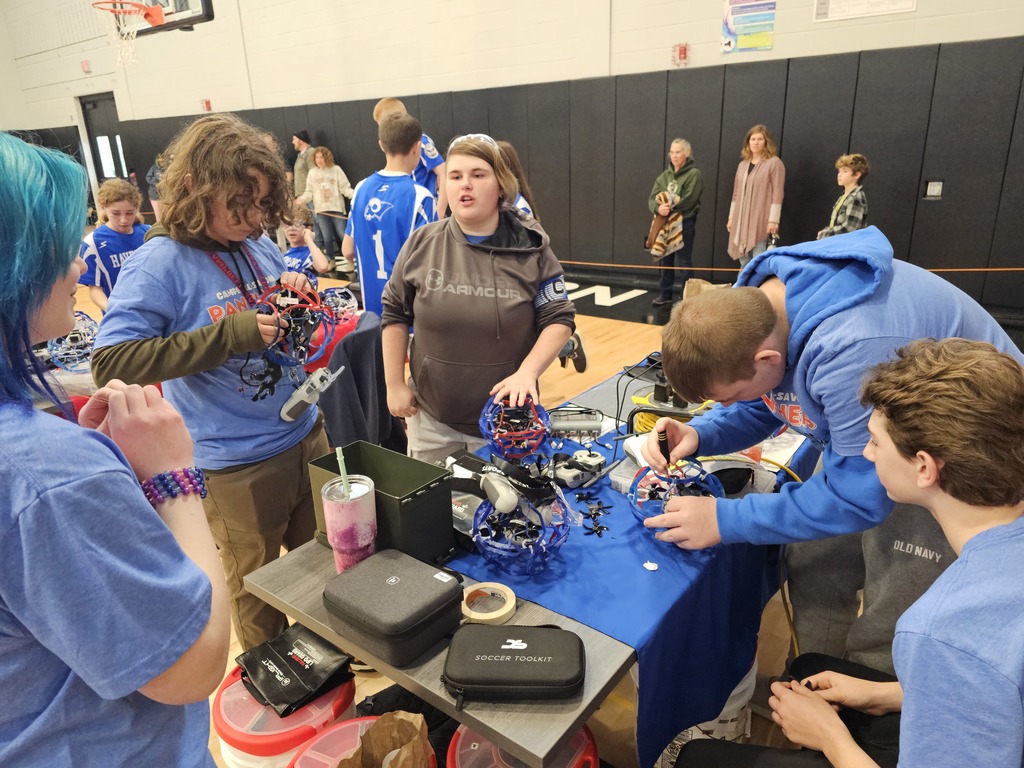 Drone soccer team working on drones at the work table.