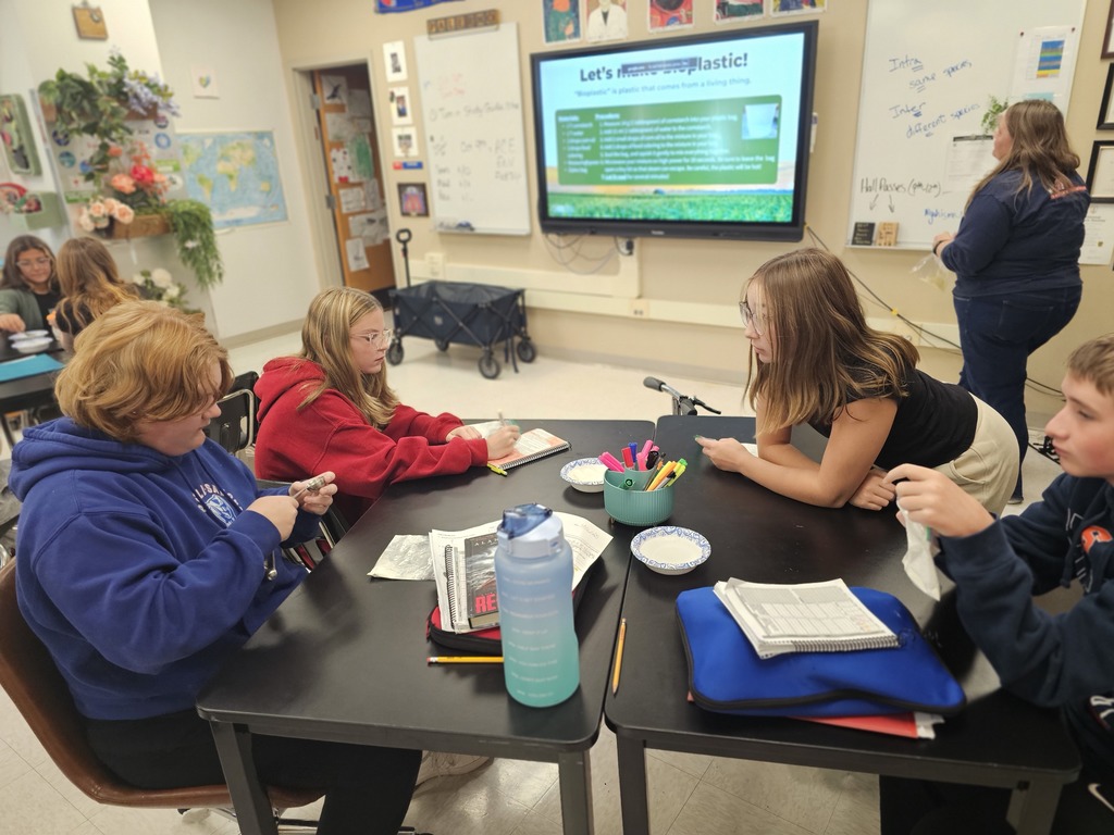 Students at table working together with baggies to make bioplastic