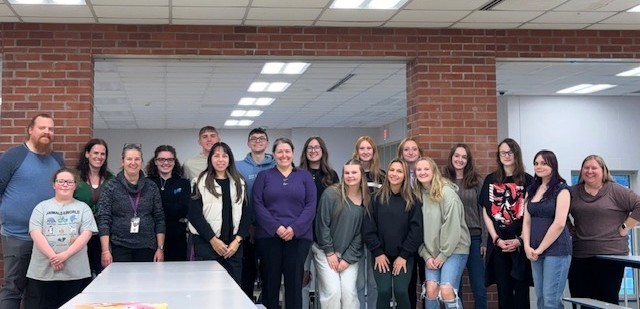 Group picture of students and teachers in the cafeteria