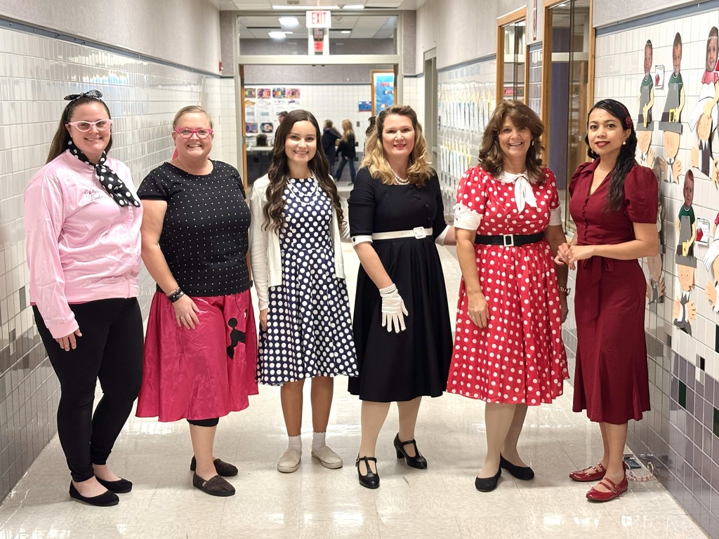 PreK teachers dressed in 1950's dresses posing for picture