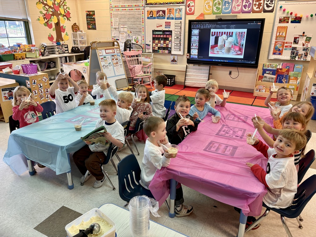 preK Class sitting at tables wearing shirts with 50 on them