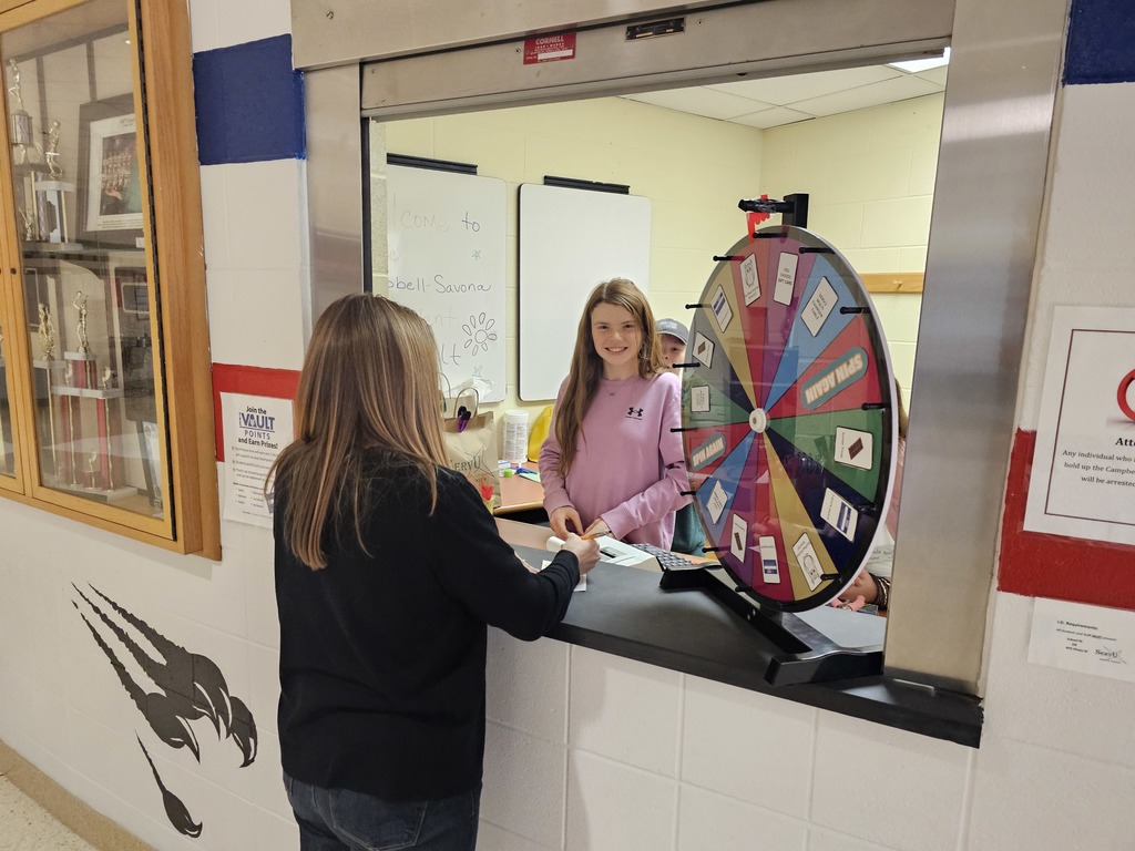 Picture of a student bank teller working to do a deposit with a faculty member