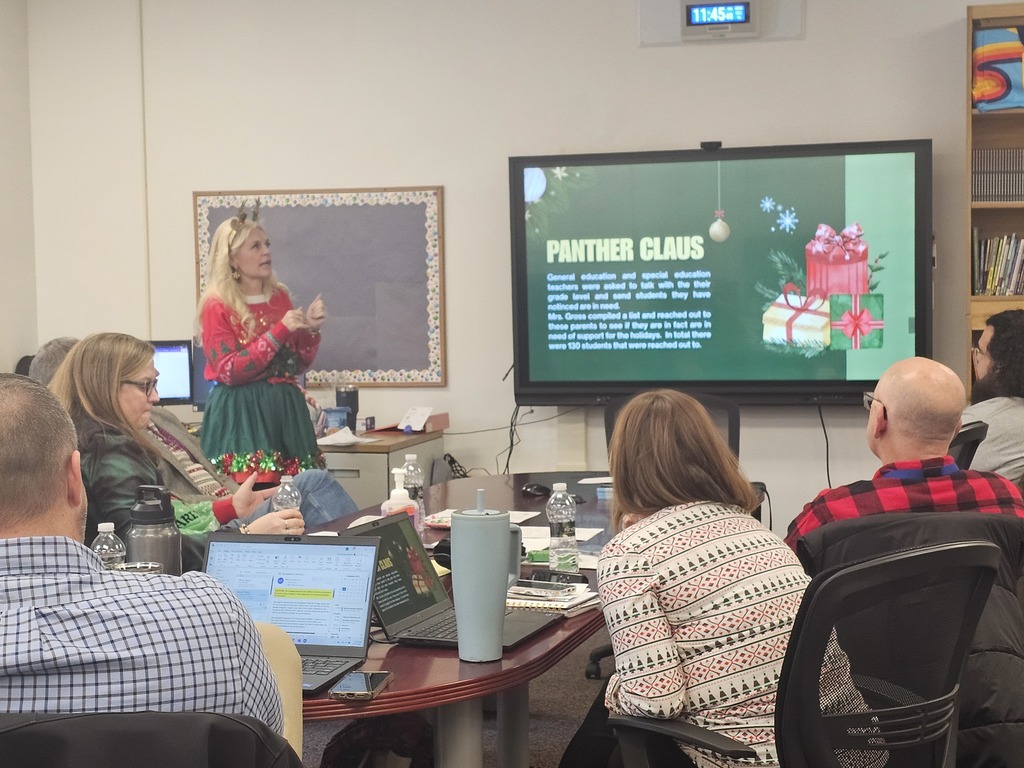Board of education sitting for presentation on Panther Claus