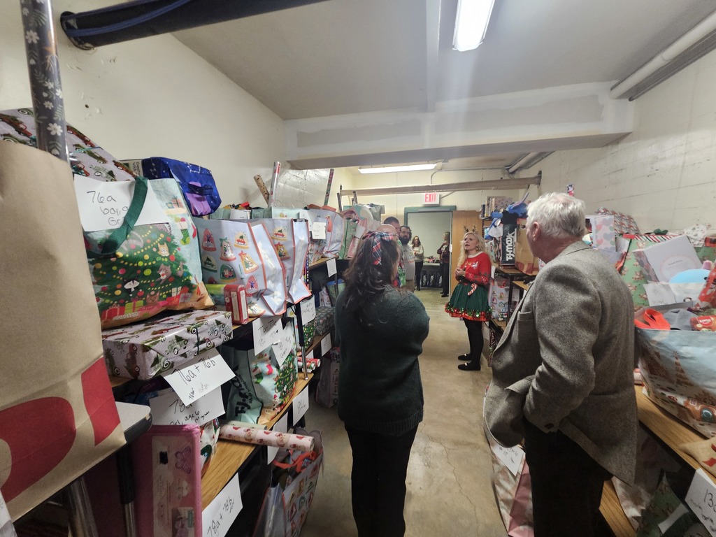 Board of education visiting the presents for Panther Claus