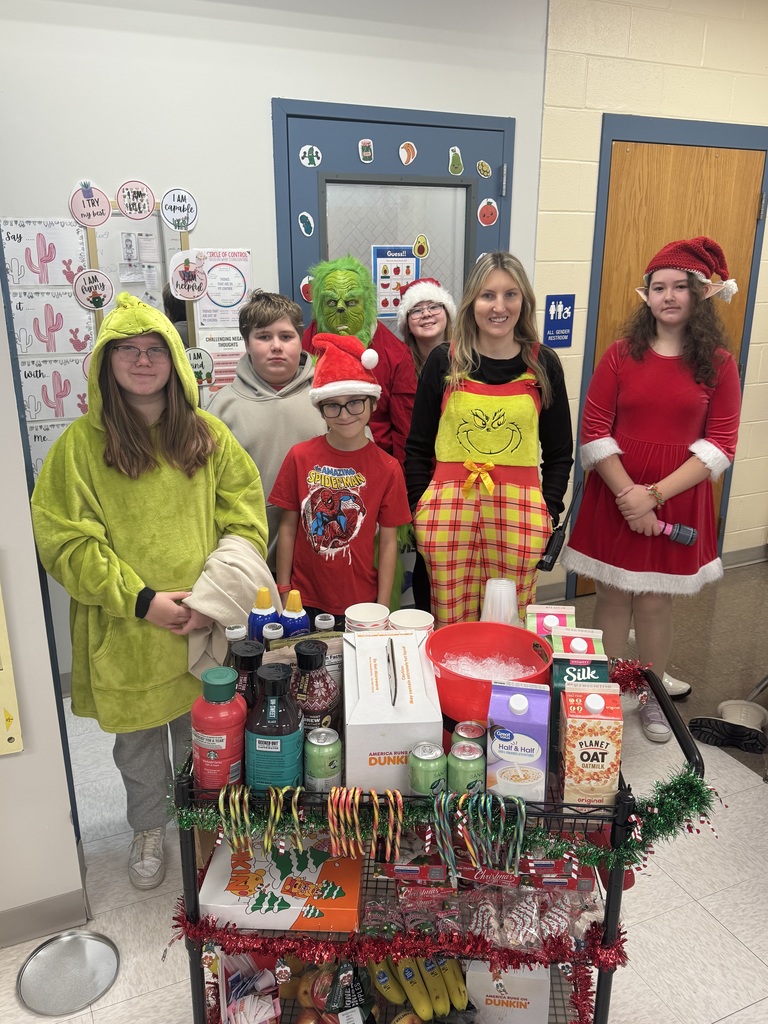 Group photo of students and counselor dressed as the grinch