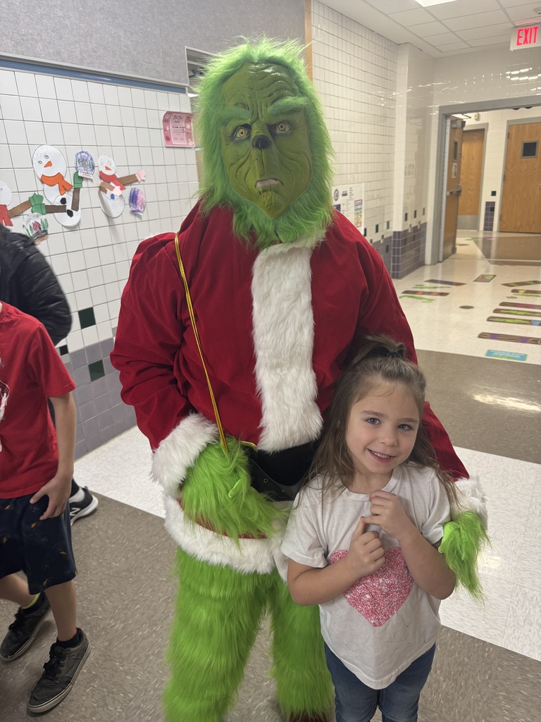 The Grinch posing with a student