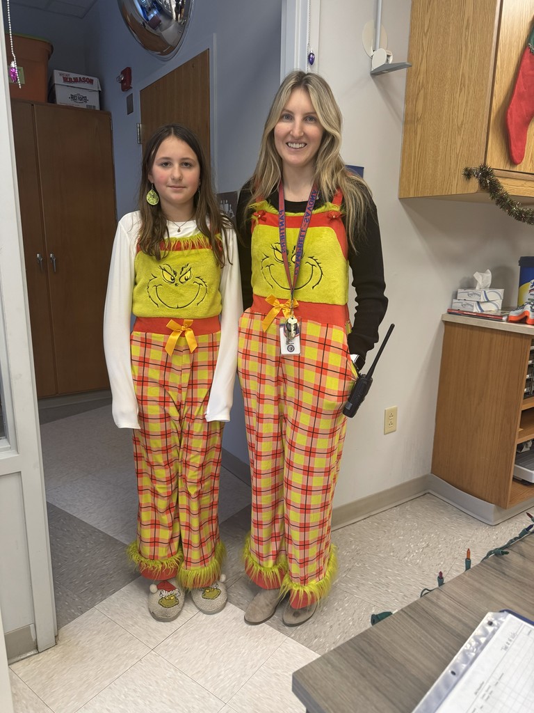 School counselor and student posing and dressed up as the Grinch