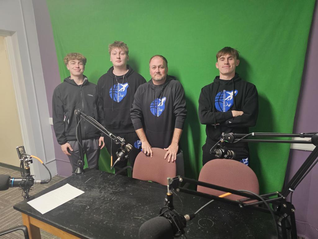 4 men standing in front of green screen