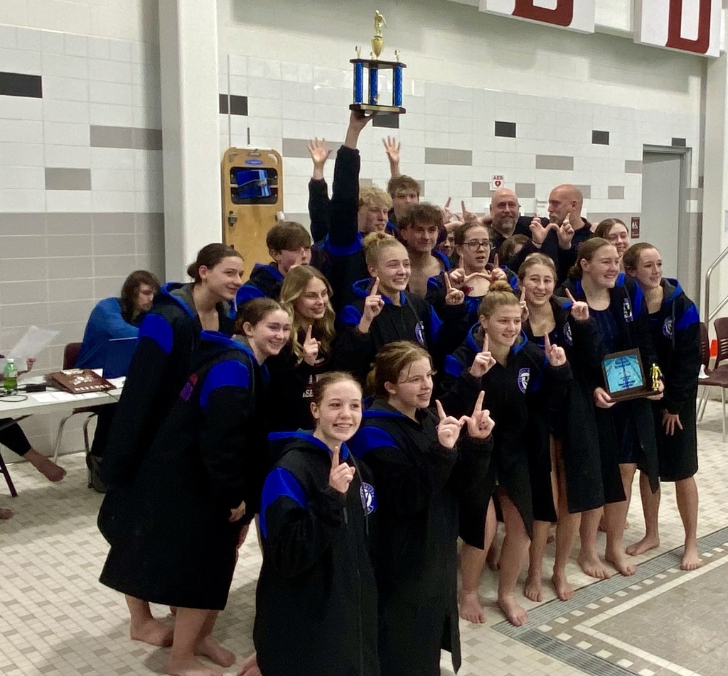 Swim team posing with trophy after winning counties