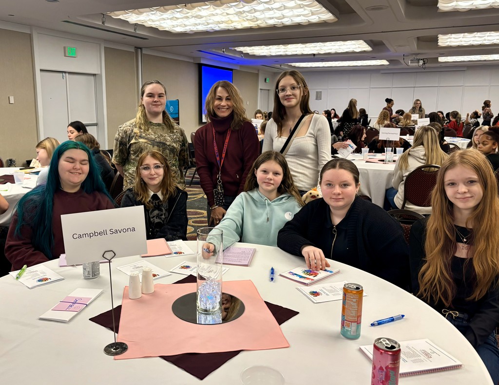 Students sitting at table at conference with a counselor