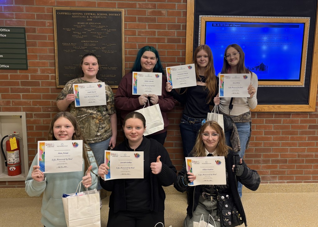 Students posing with certificates
