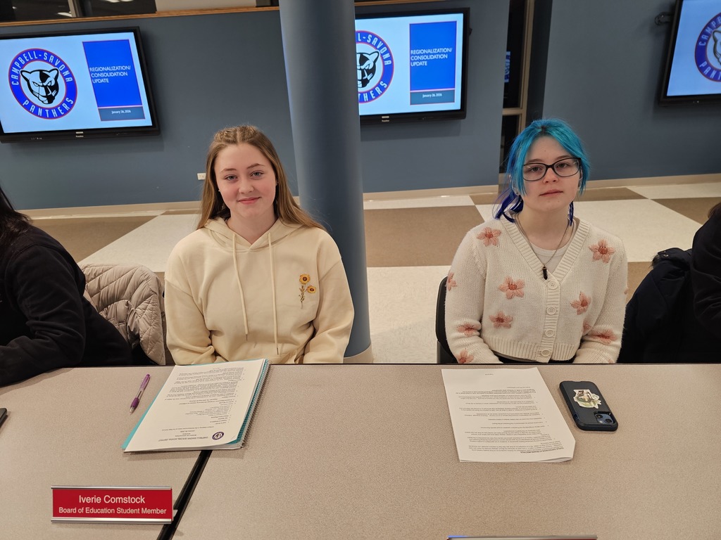 2 student council members at the board of ed meeting as representative sitting at table
