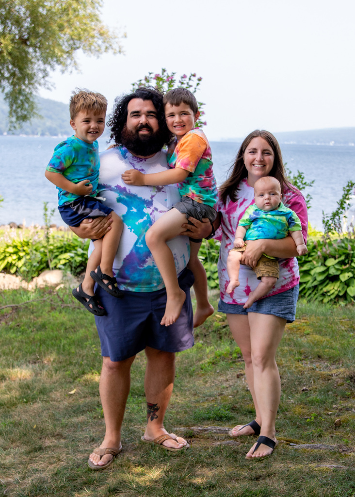 Family picture of husdand and wife holding their three children