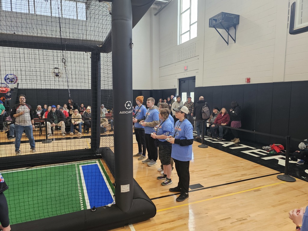 Drone soccer team with controllers in front of the arena