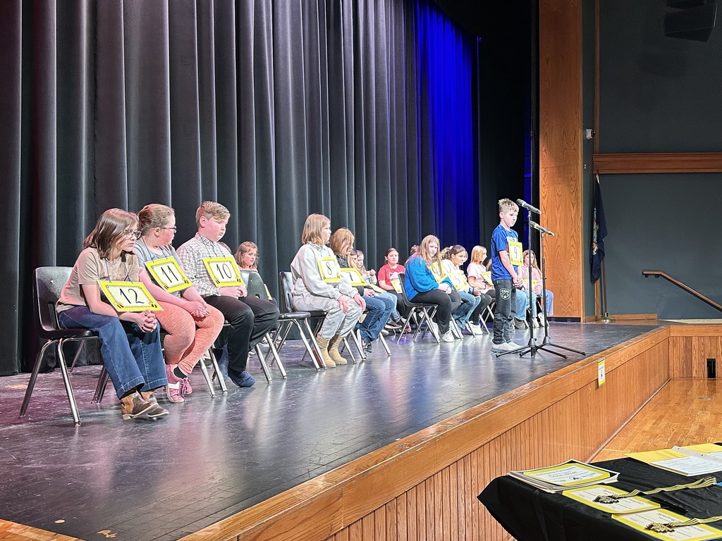 Students sitting on stage for the spelling bee
