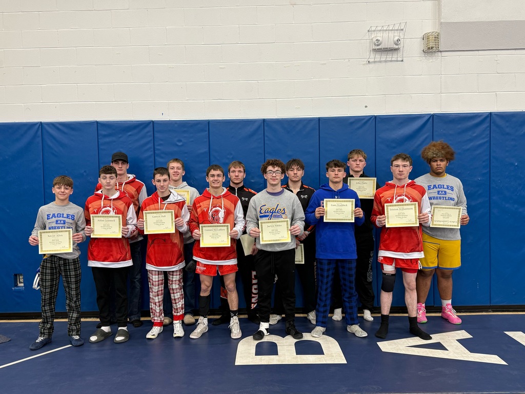 Group shot of wrestlers holding certficates