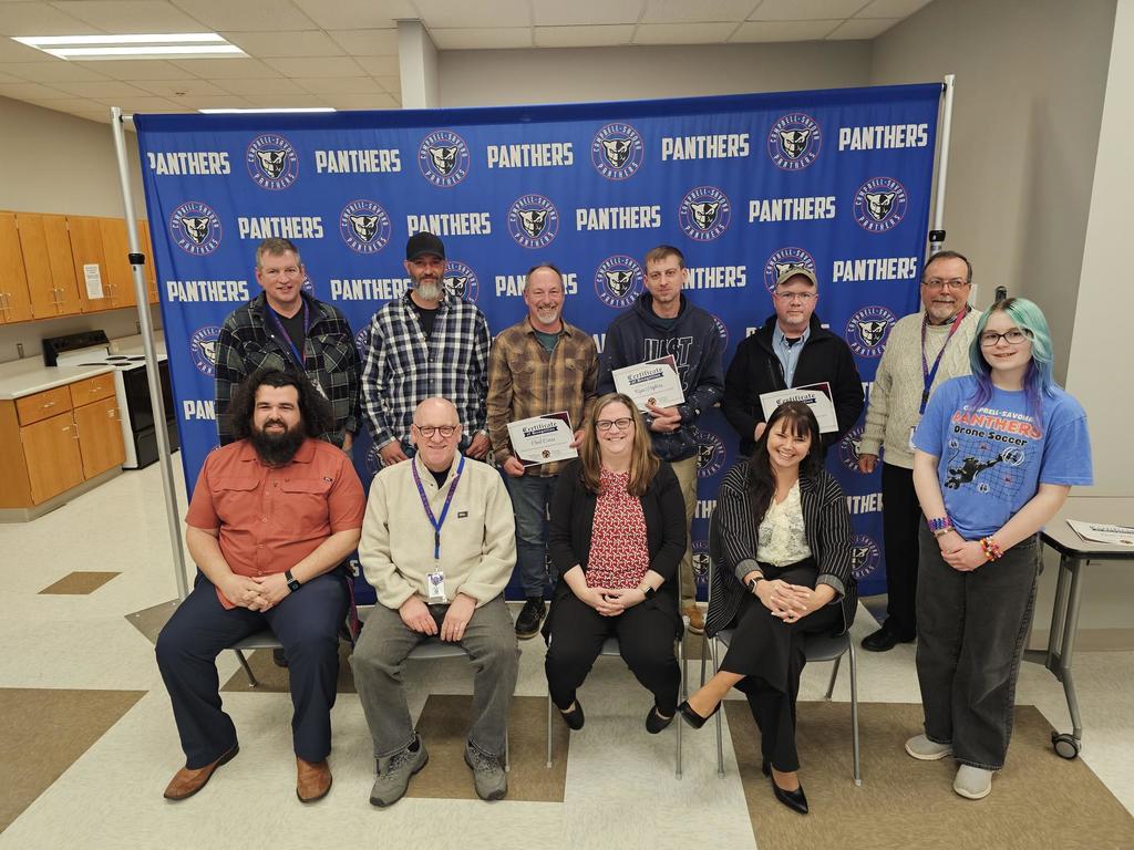 BOE in front of panther banner recognizing our maintenance workers.