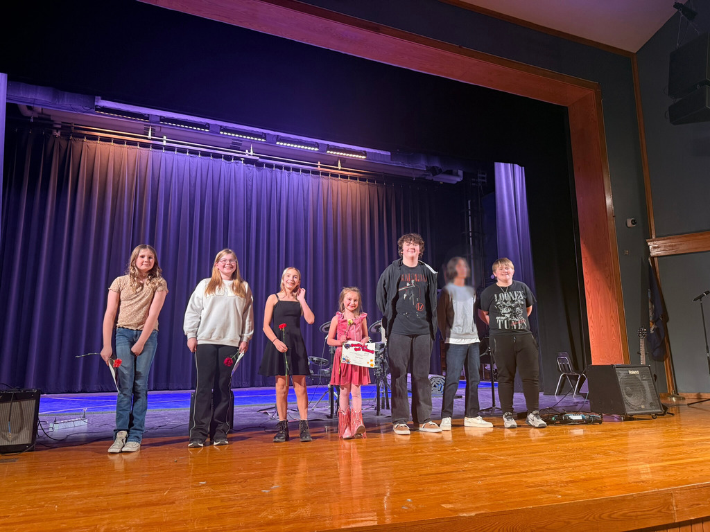 GRoup of students standing on stage at talent show