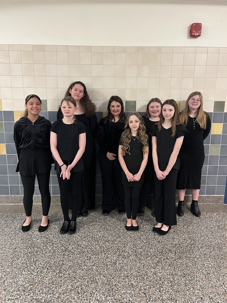 6th Chorus dressed in black posing for picture