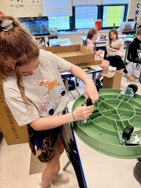 STudent putting wheels on planter