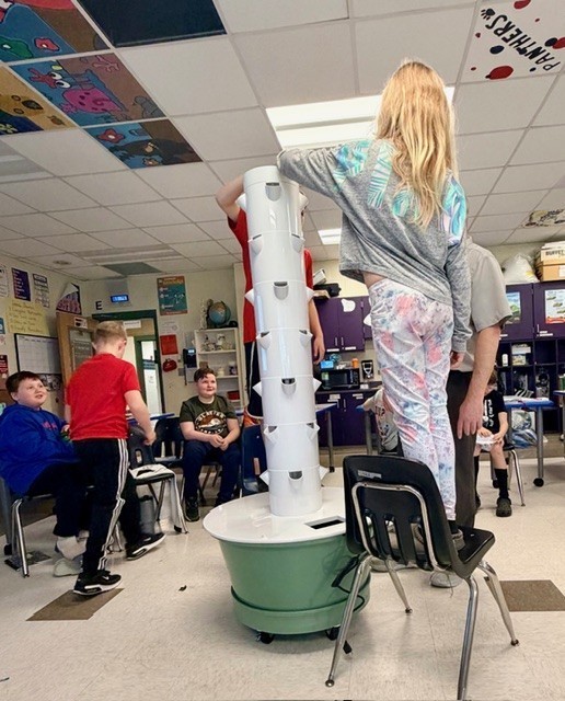 Teacher and students building planter