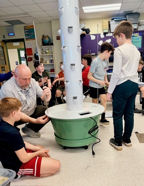 Teacher and students building planter