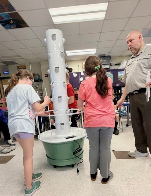 Teacher and students building planter
