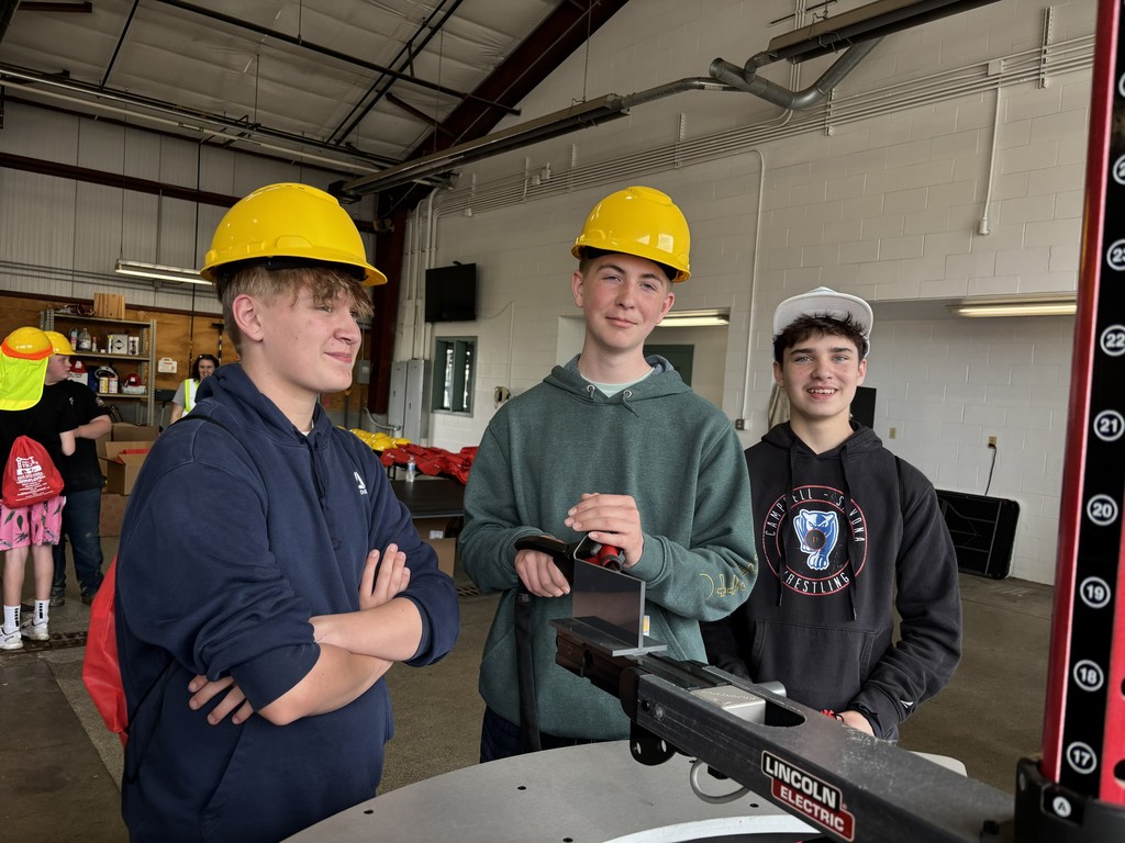 Students in hard hats at a saw