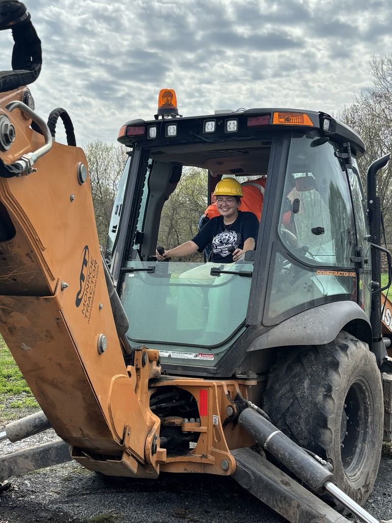 STudent driving an excavator