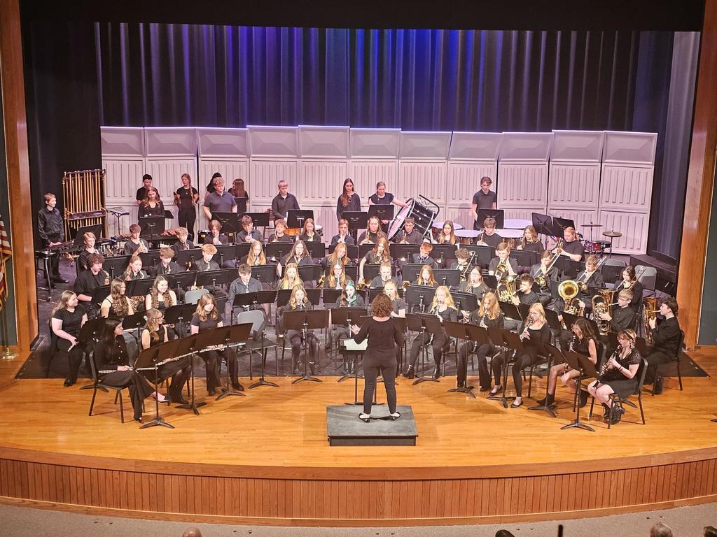 Jr HS band on stage wearing black