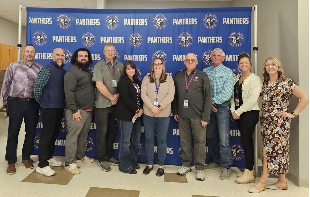 Picture of BOE with administration in front of panther banner