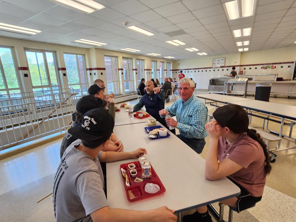 BOE members sitting with students eating lunch