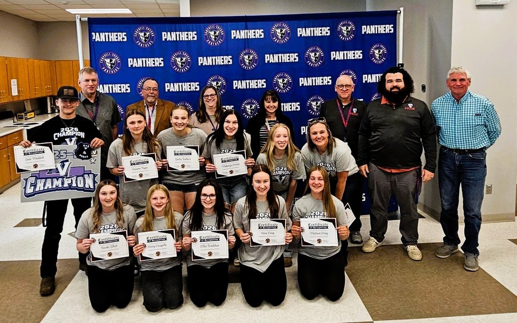 Group photo of BOE with student athletes in front of Panther Banner.