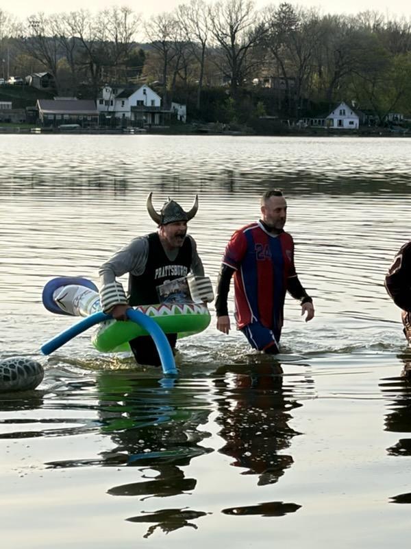 People dressed up as school mascots in the water