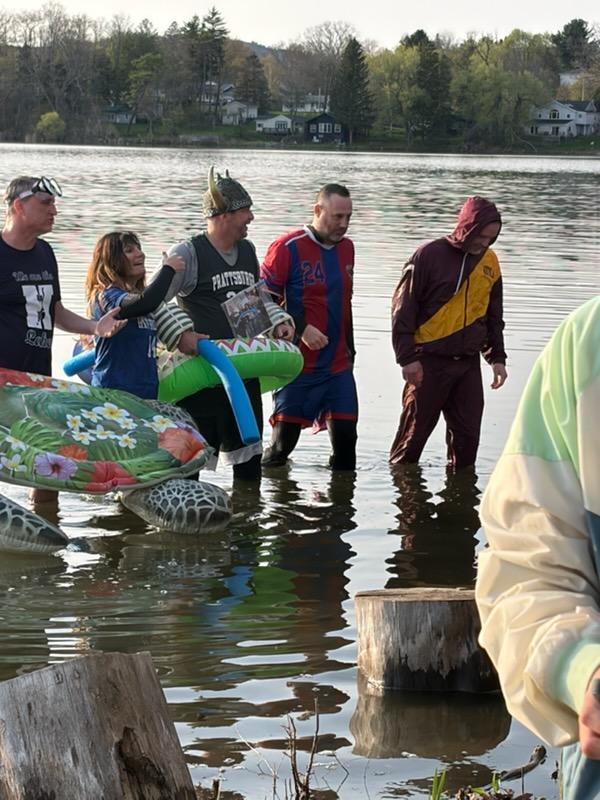 People dressed up as school mascots in the water