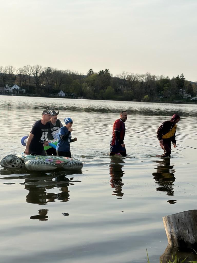 People dressed up as school mascots in the water